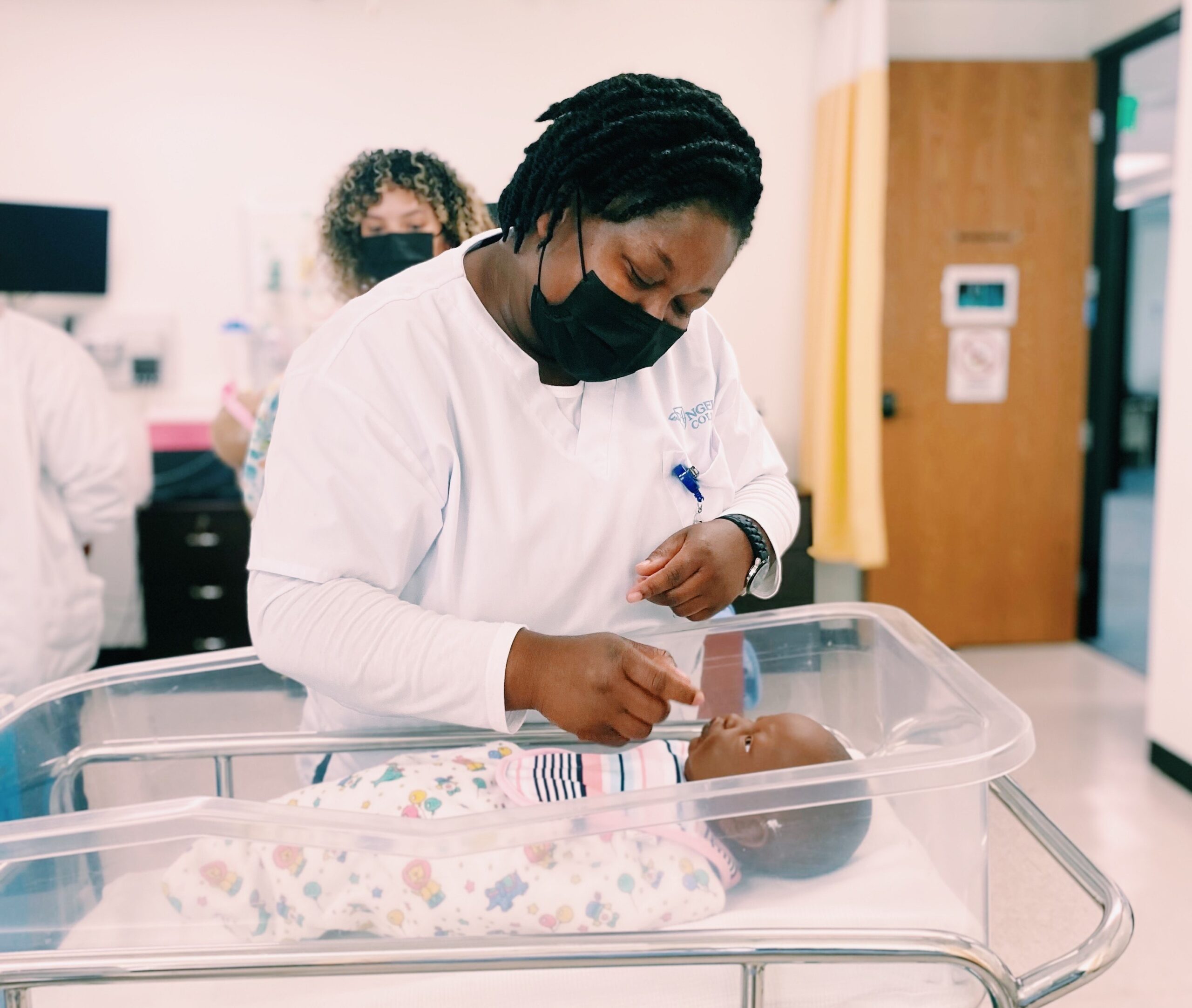 LVN Student attends to a baby doll in the simulation lab