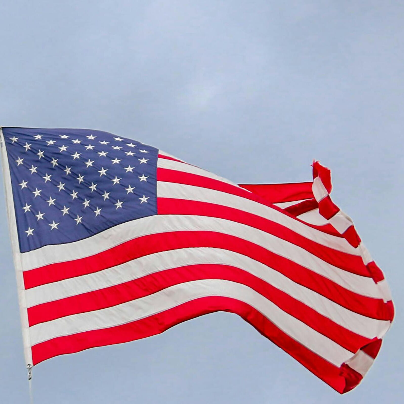 A vibrant image of the American flag waving proudly against a clear blue sky, symbolizing freedom.