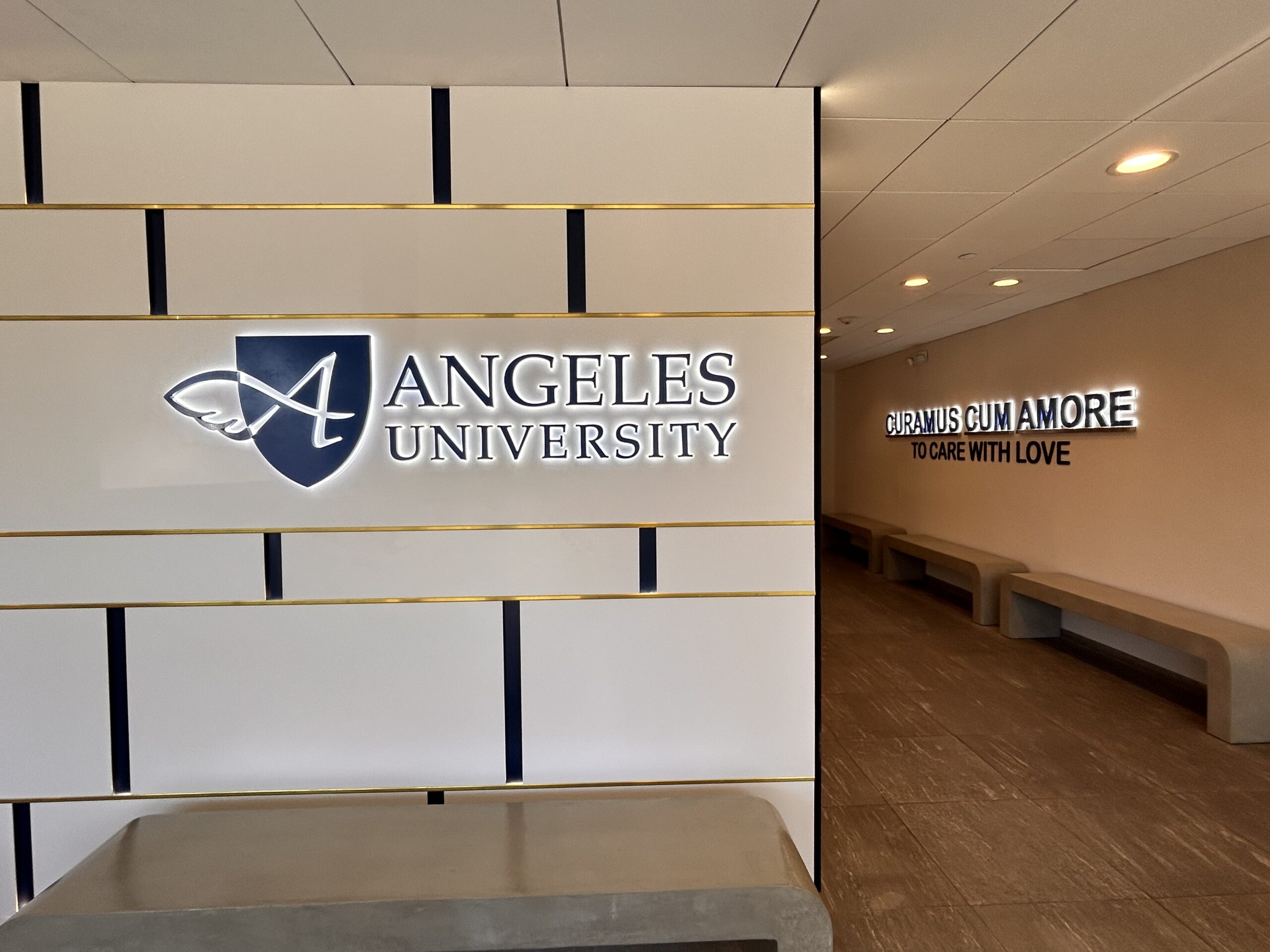 Angeles University Sign in hallway with school mission on the wall